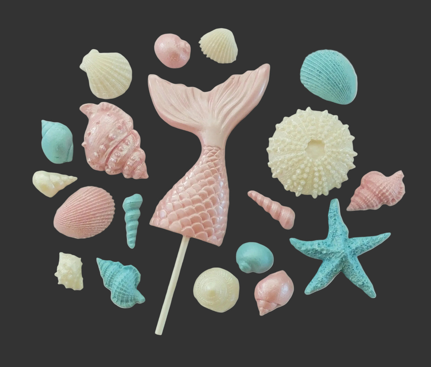 Pink mermaid tail surrounded by colorful shells, edible chocolate decorations by Cake Candy NZ