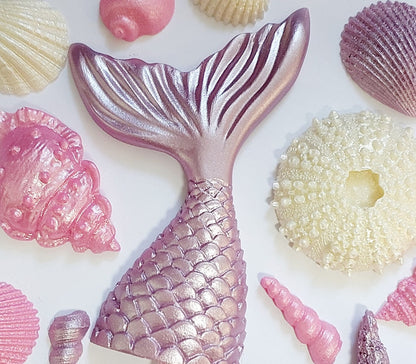 Close up of chocolate mermaid tail and shells in lilac, pink and cream colours. Edible  decorations by Cake Candy Nz.