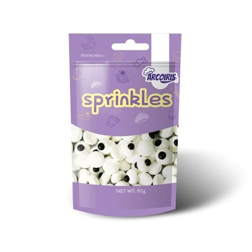 A bag of Arcouris Sprinkles candy, featuring a purple resealable stand-up pouch with a clear window showing white sprinkles with black eyes inside.