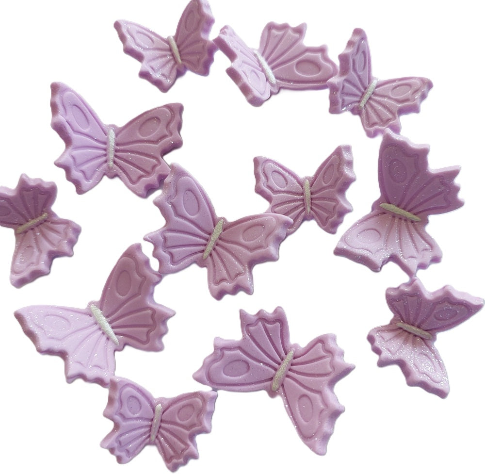 A set of edible fondant icing butterflies in a lilac colour with sparkle