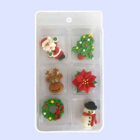 a set of Christmas themed royal icing cake decorations