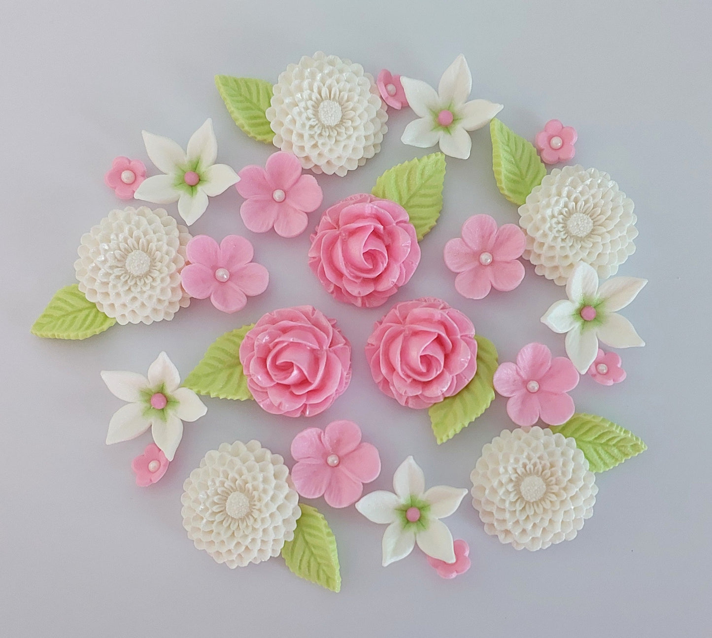 Flower arrangement with dahlias, roses and leaves in pink, white and green colours. Edible fondant icing decorations by Cake Candy NZ