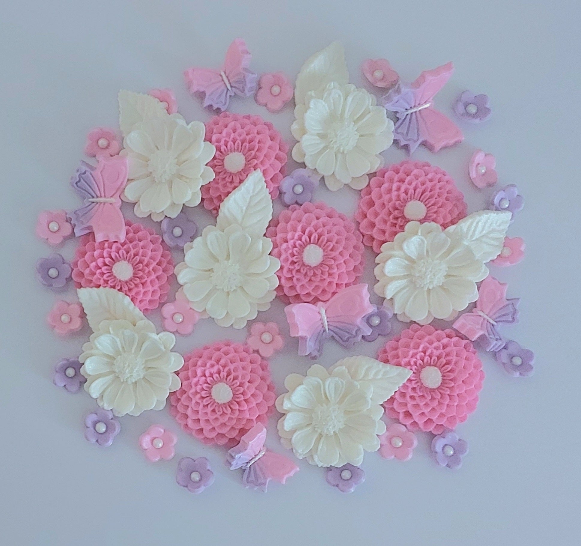 Decorative arrangement of pink, lilac and white flowers with butterflies, edible fondant sugar decorations by Cake Candy NZ