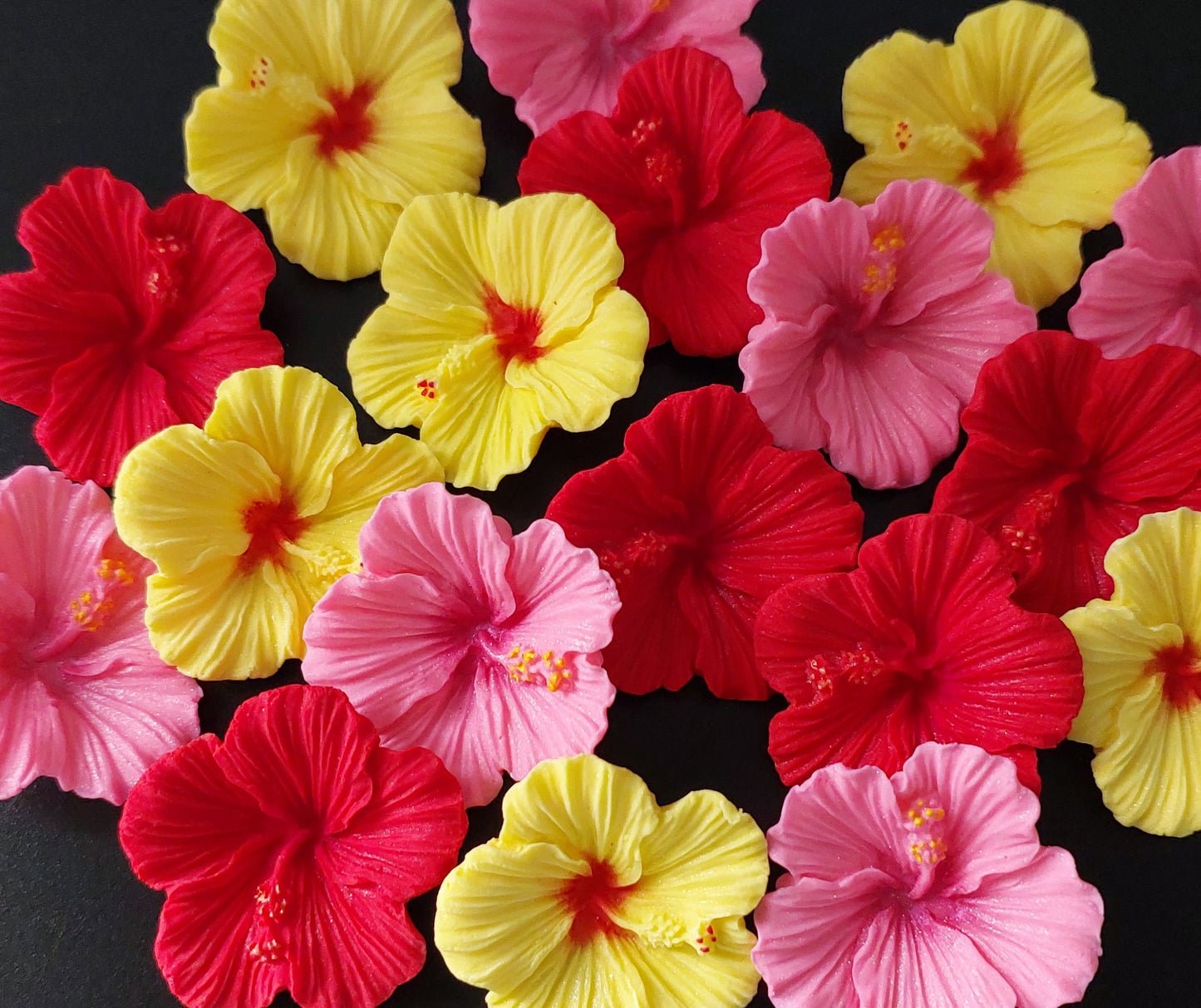 36 tropical hibiscus flowers in red, pink and yellow colours. Edible fondant icing decorations by Cake Candy NZ