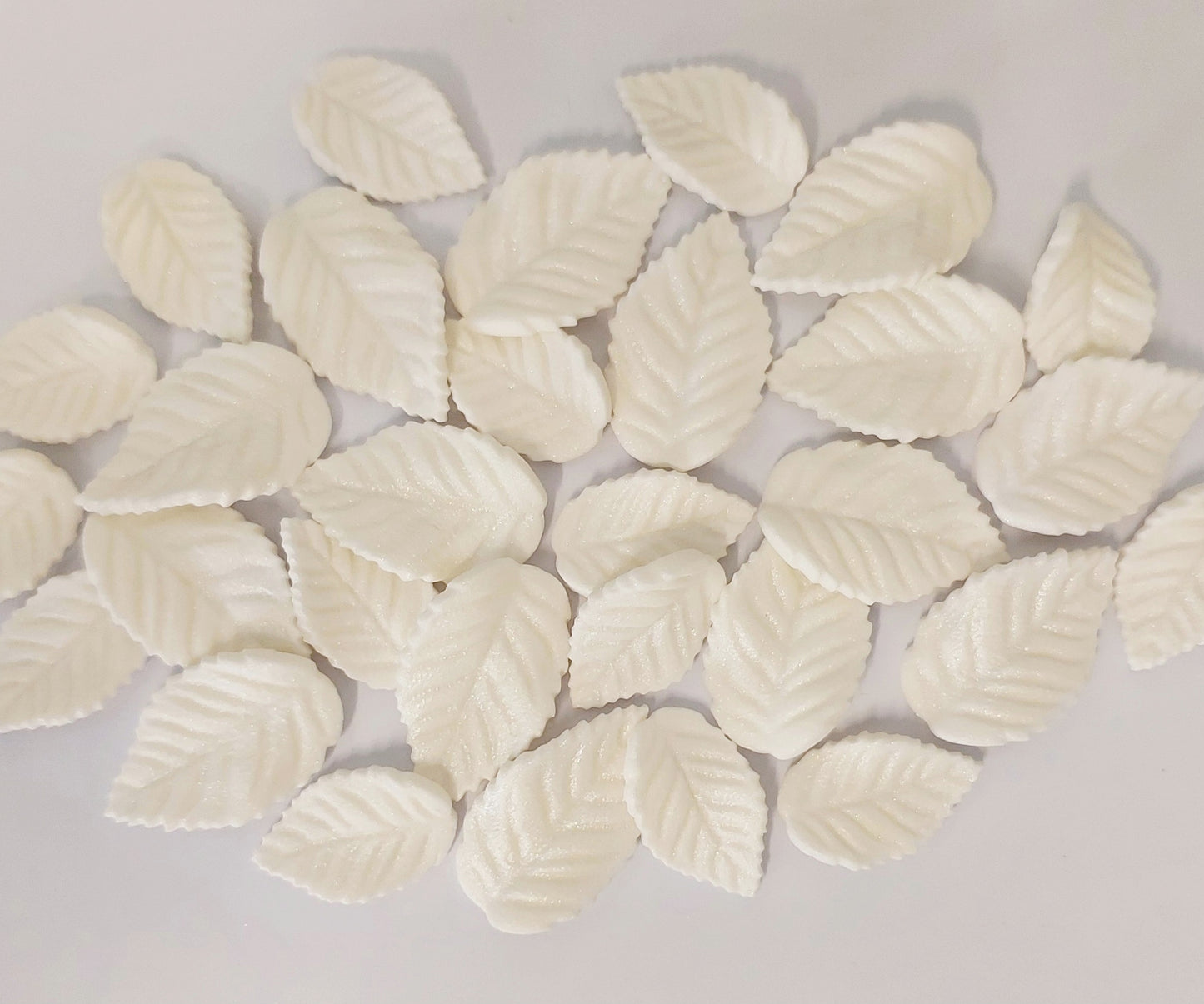Thirty white leaves in two sizes, edible fondant decorations by Cake Candy NZ