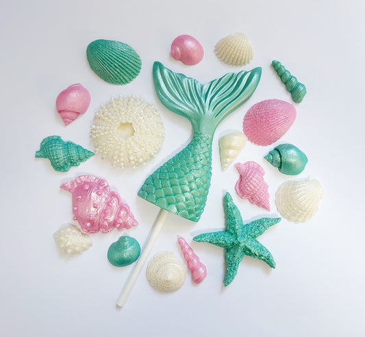 Chocolate mermaid tail, shells and starfish in aqua green, pink and cream colours. Edible decorations by Cake Candy Nz.