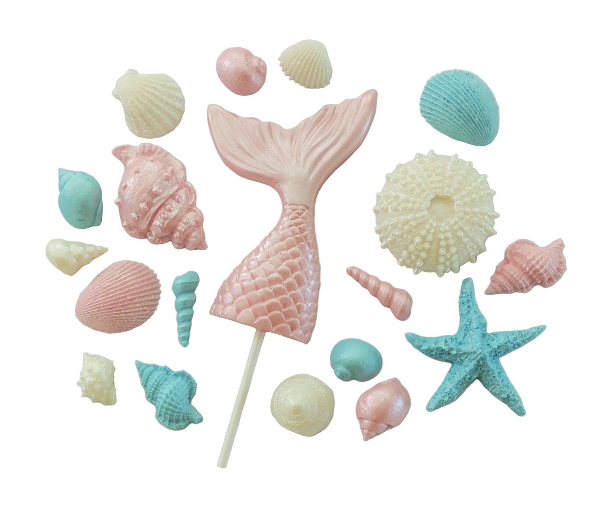 Pastel-colored pink mermaid tail cake topper surrounded by seashells and a starfish. Edible chocolate decorations by Cake Candy NZ