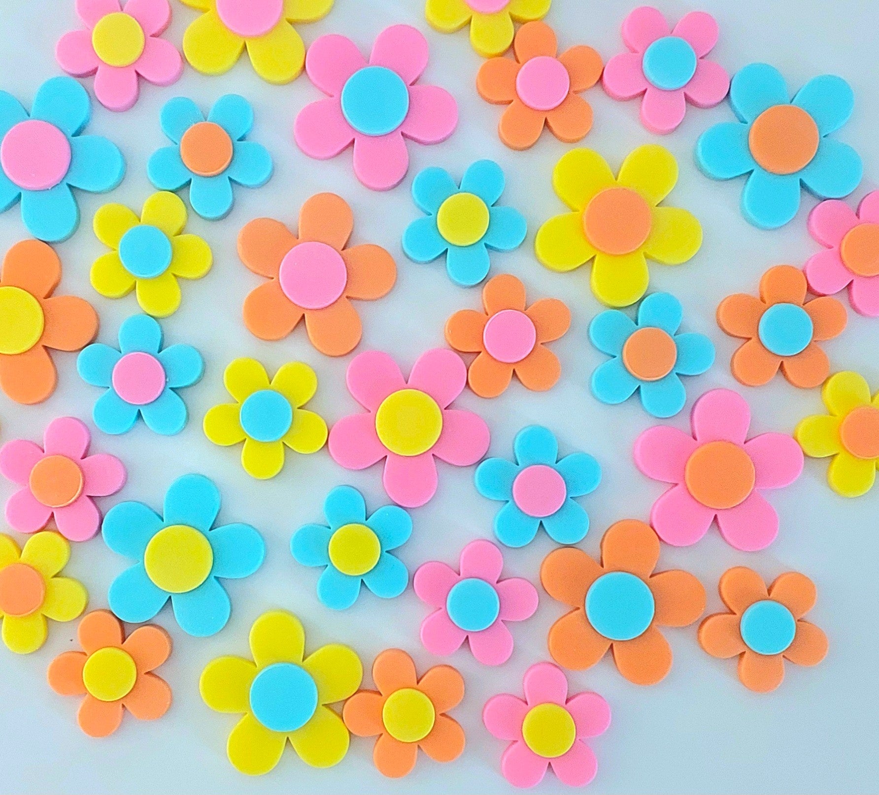 Thirty six colourful blossoms, yellow, orange, pink and blue. Edible fondant icing decorations by Cake Candy NZ