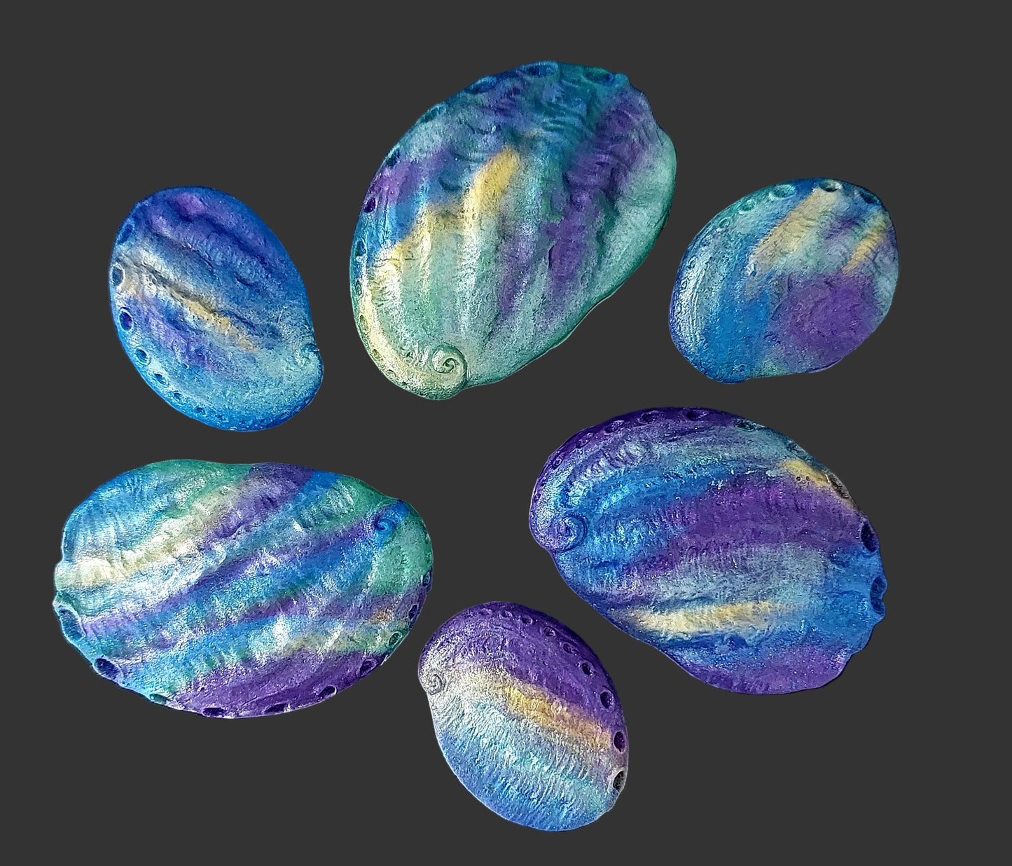 Paua shells blues, greens. purples and gold shimmer. Edible fondant decorations by Cake Candy NZ