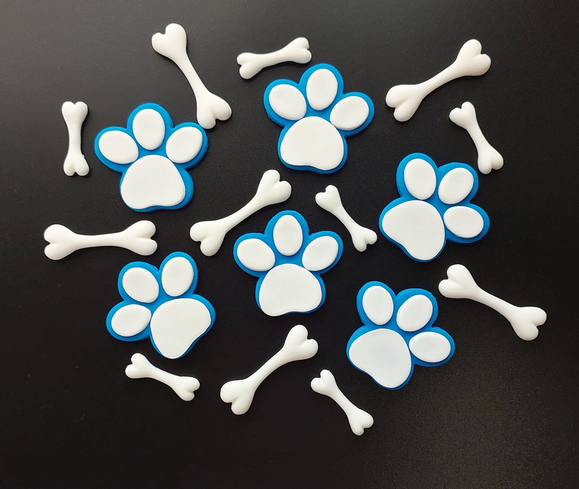 A set of 6 paws and twelve bones, white and blue colours. Edible fondant decorations by Cake Candy NZ