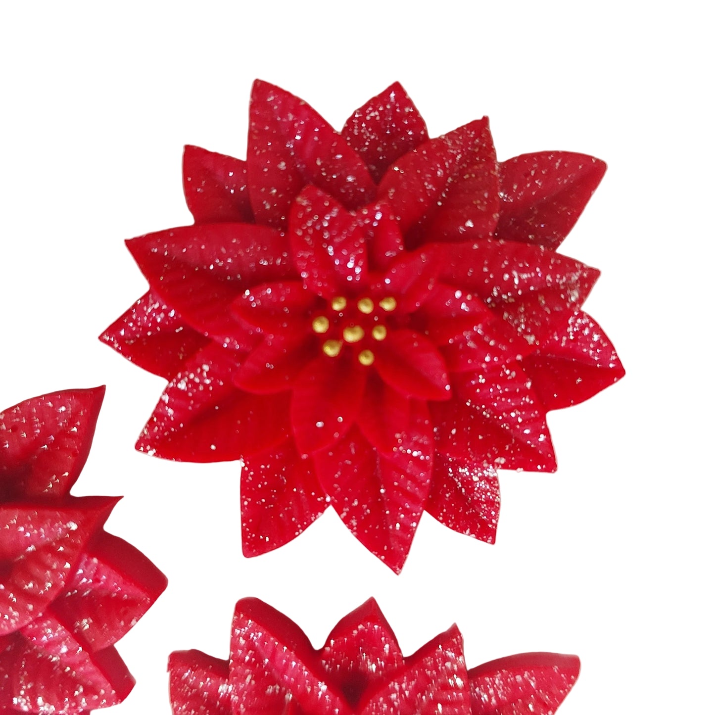 Close up of large fondant icing poinsettia flower, red with gold centre
