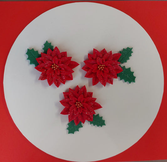 Red poinsettia flowers with green leaves on a white circle against a red background