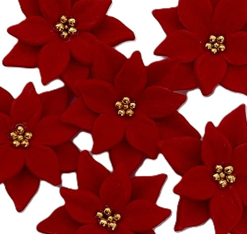 Six edible red fondant poinsettia flowers with small gold bead centers, arranged on a plain white background. By Cake Candy NZ
