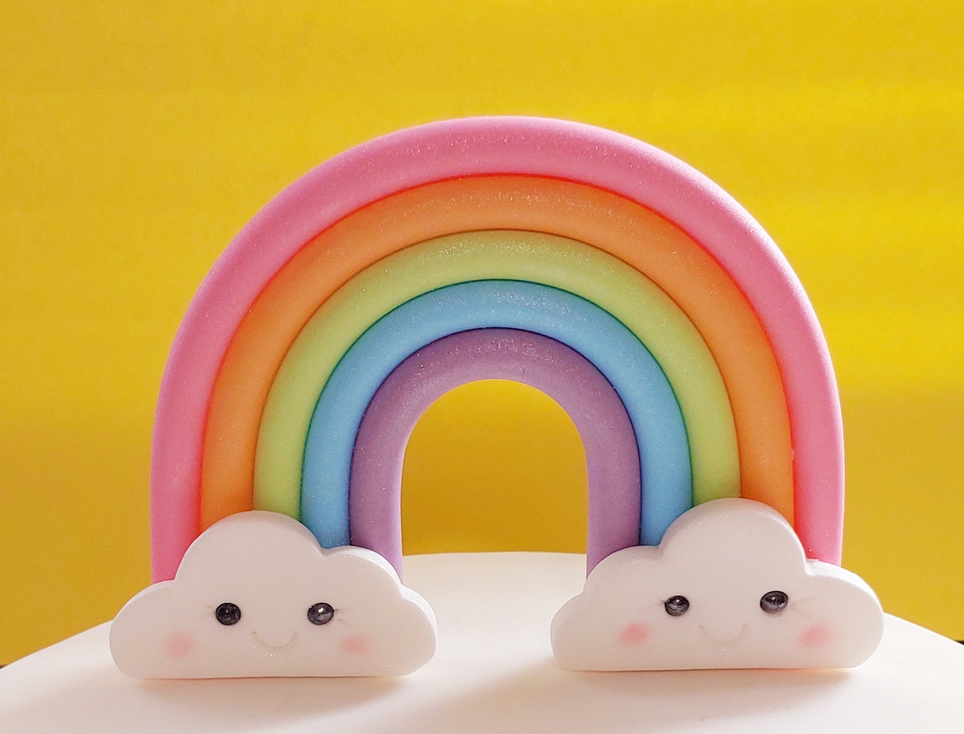 Colouful rainbow with smiling clouds, fondant icing decoration by Cake Candy NZ