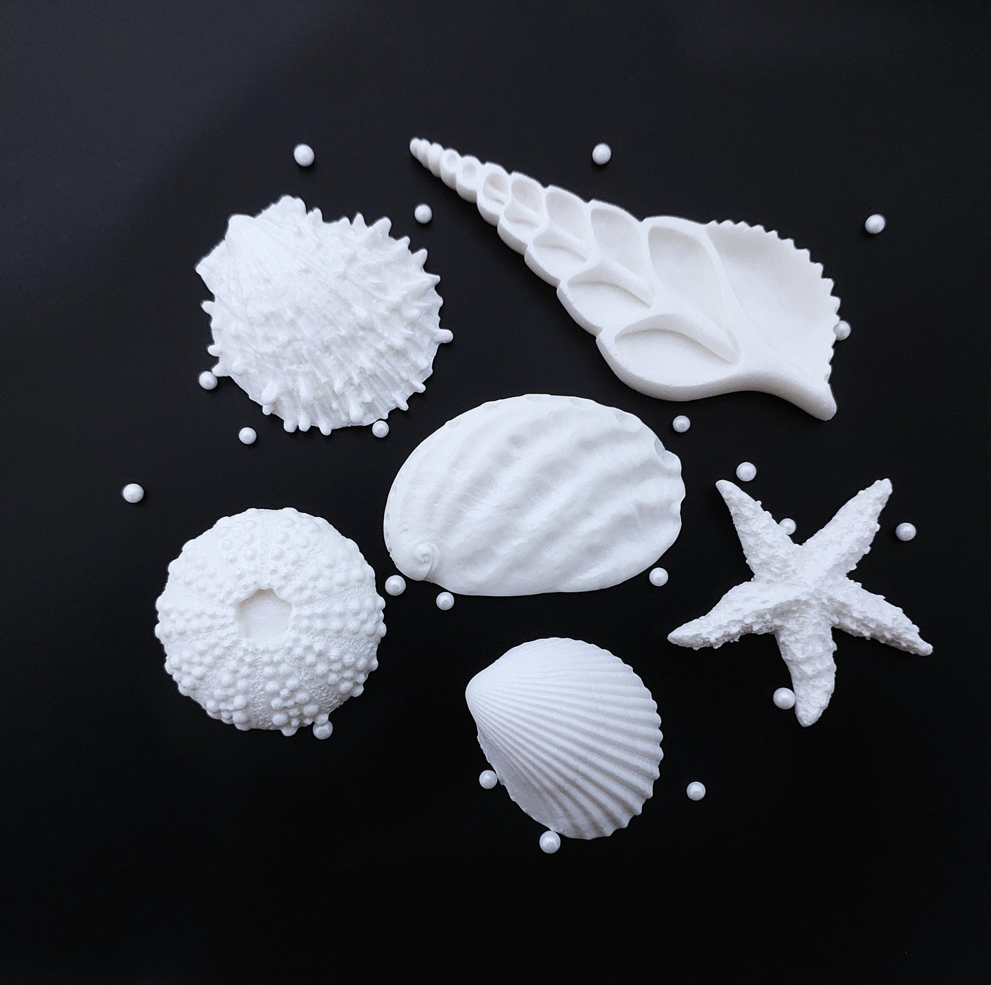 A set of 6 large white fondant icing shells with sugar pearls