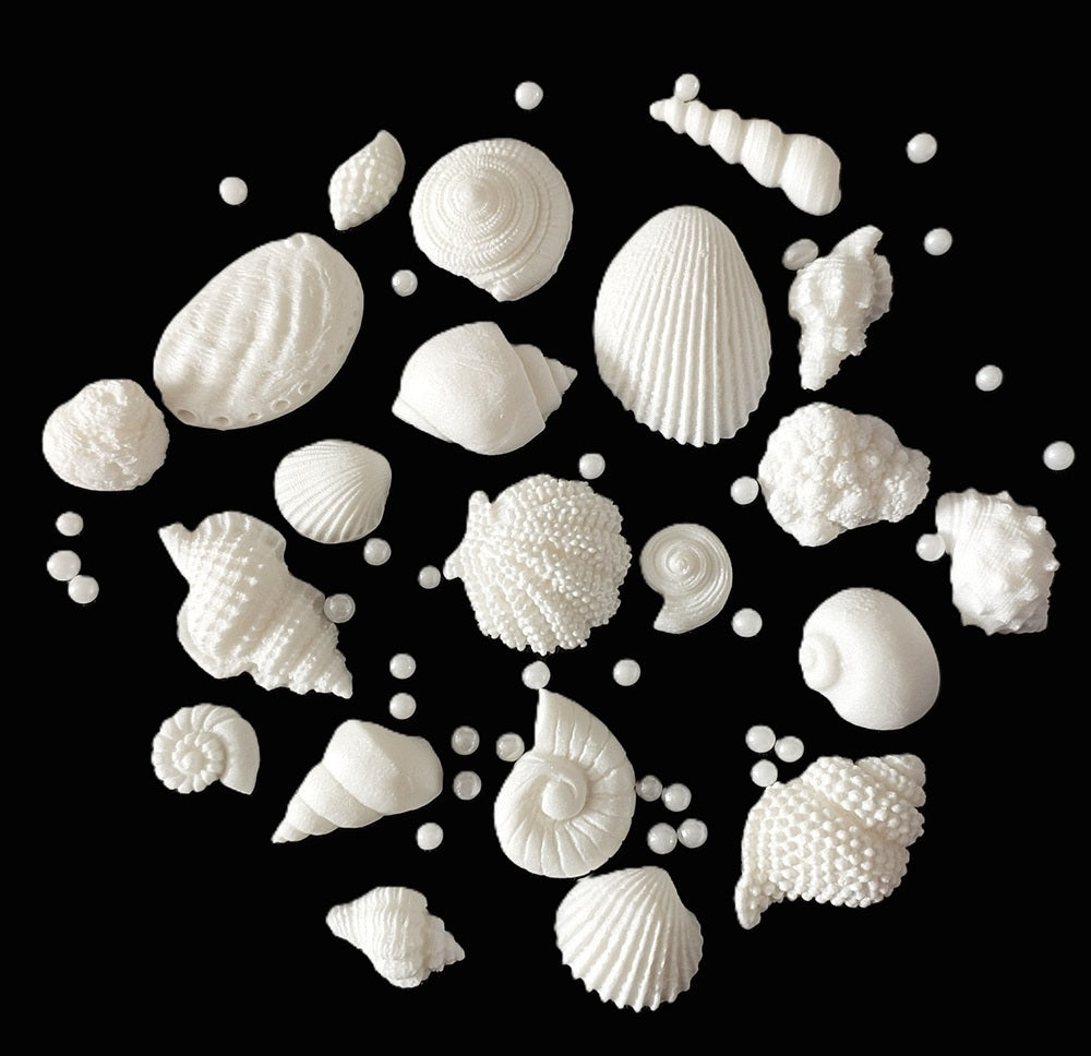 A set of 20 small white fondant icing shells plus sugar pearls