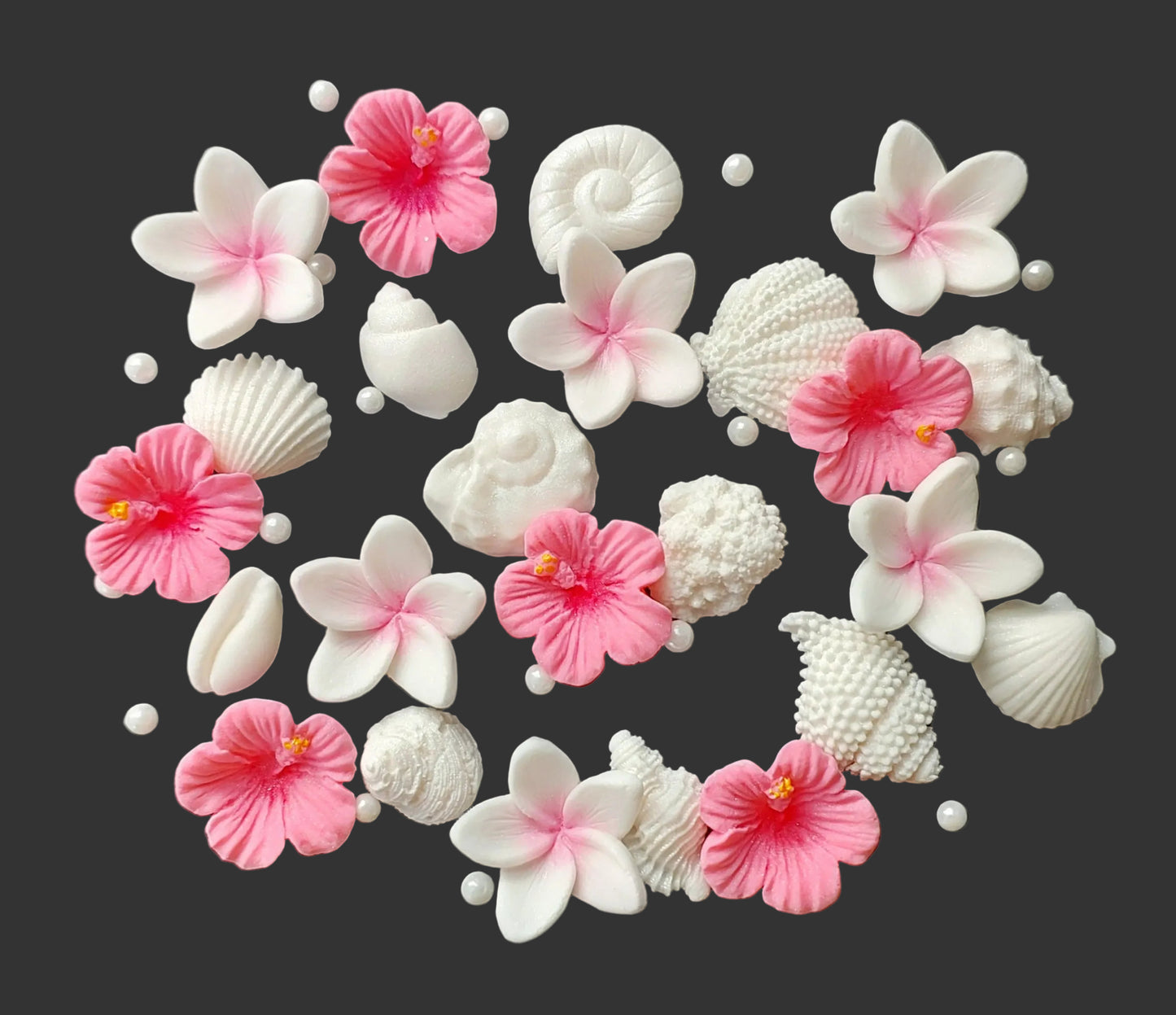 Small shells and tropical flowers in pink and white. Edible fondant icing decorations by Cake Candy NZ