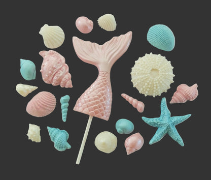 Pink mermaid tail  surrounded by colorful shells, edible chocolate decorations by Cake Candy NZ