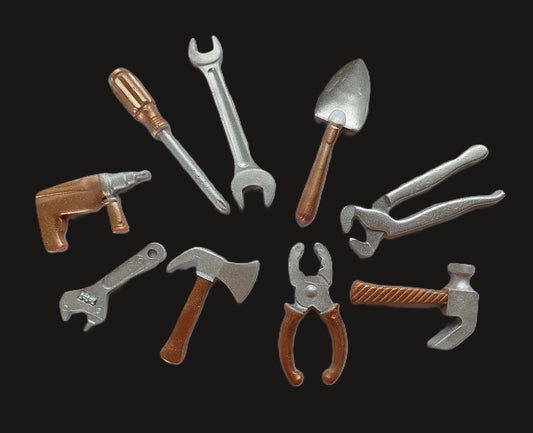 A collection of various edible fondant cake decorations by Cake Candy NZ. Designed to look like tools such as a wrench, hammer, and pliers, with a shimmer finish.